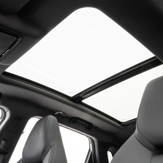 Vista interna da cabine do Jetour S06 mostrando o teto solar panorâmico de vidro.